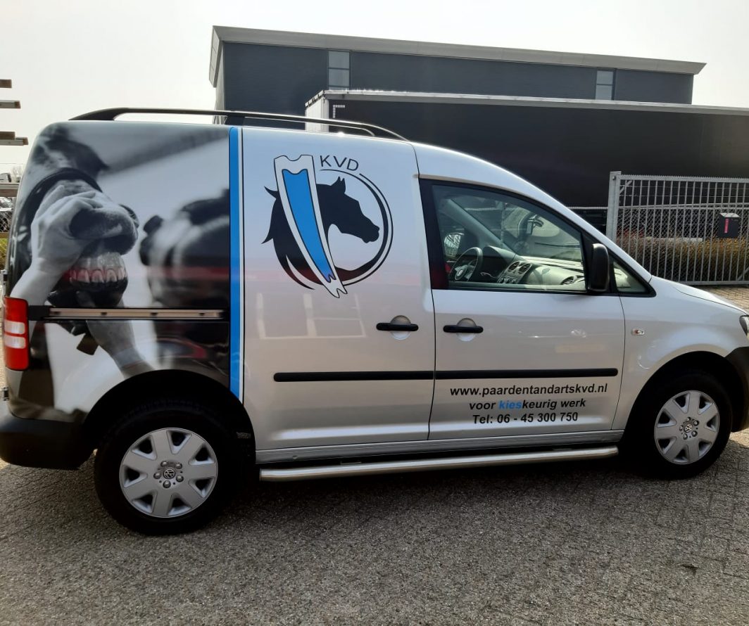 Volkswagen Caddy met paardenfoto, KVD-logo en contactgegevens
